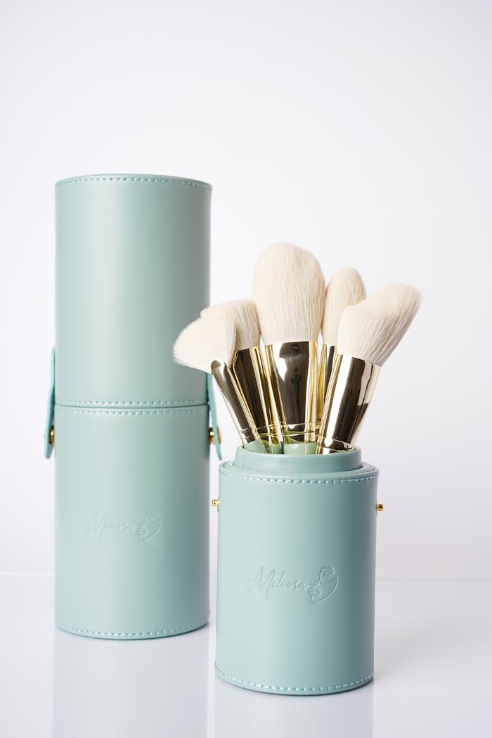 Sophisticated makeup brushes with soft bristles in turquoise holders, perfect for beauty routines.
