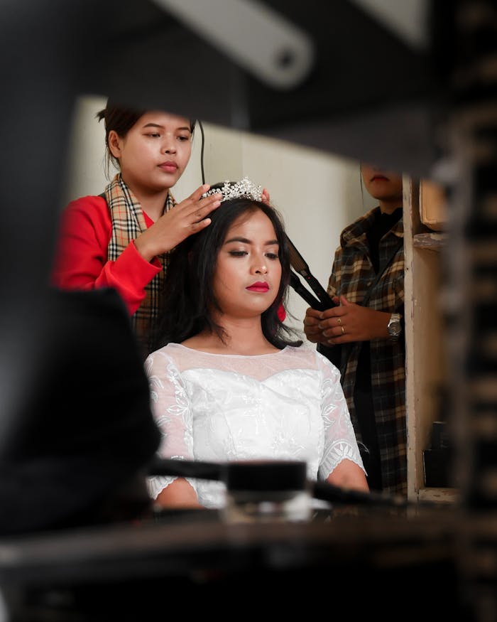 Bride getting ready with makeup and hair styling for her wedding in Jowai, India.