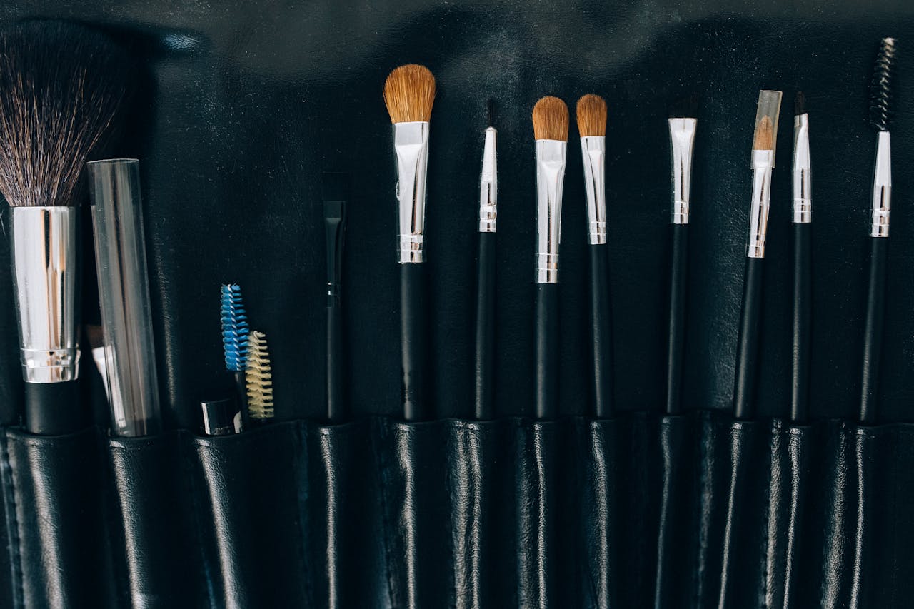 Various makeup brushes neatly arranged in a black leather case, perfect for beauty professionals.